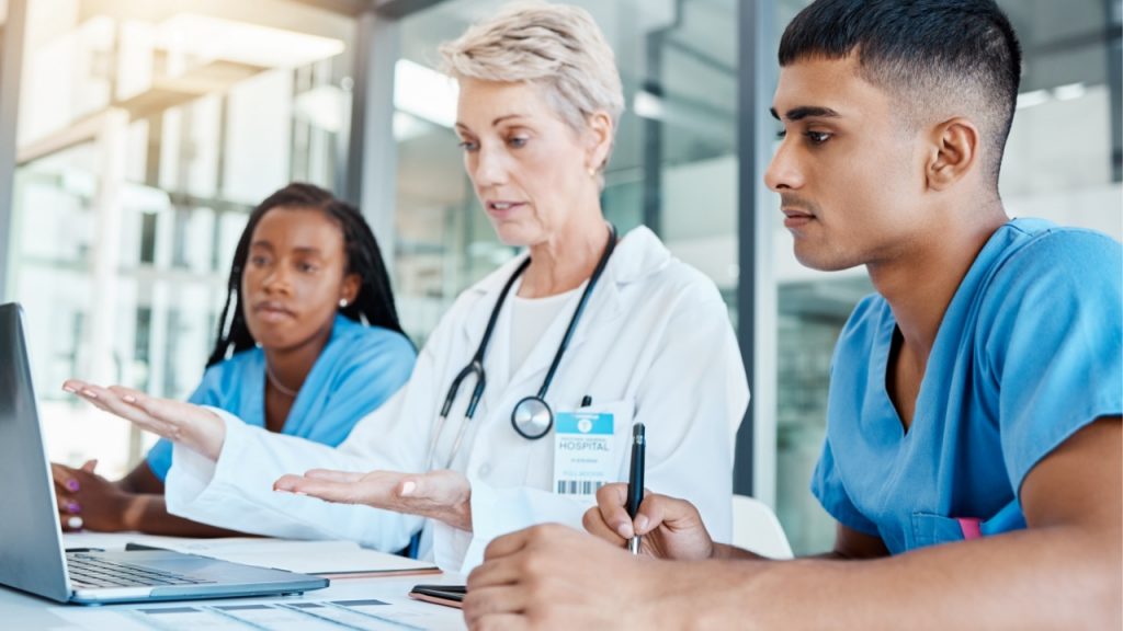 Healthcare workers looking at laptop