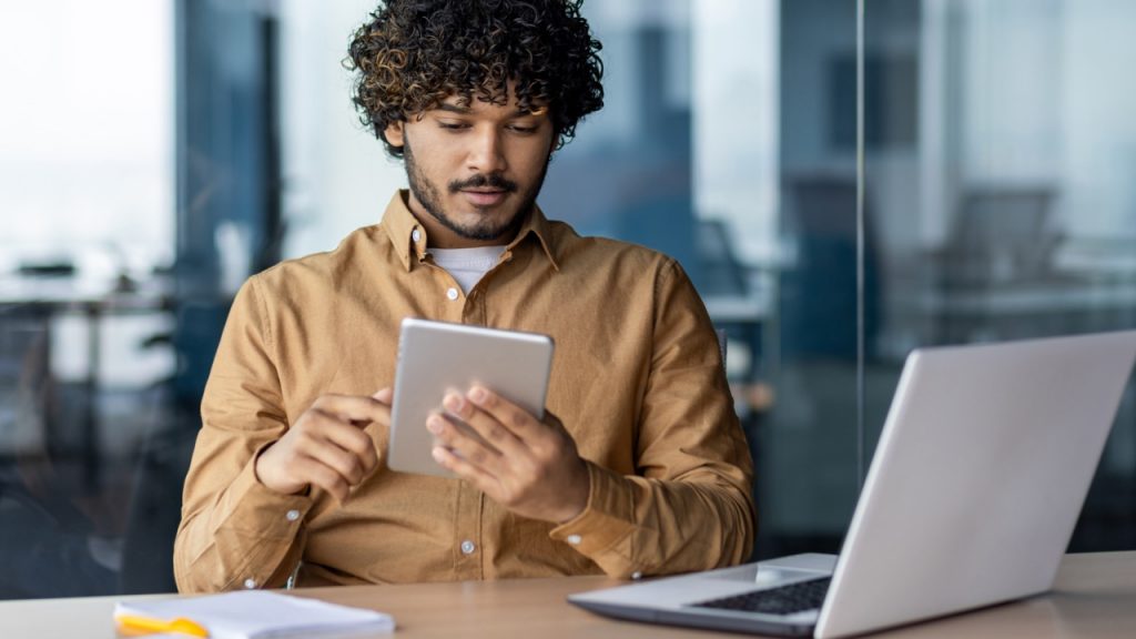 person filling out an application on tablet