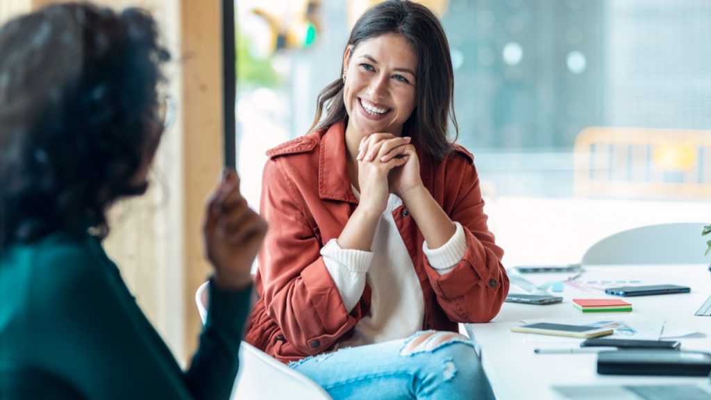 student smiling at another student