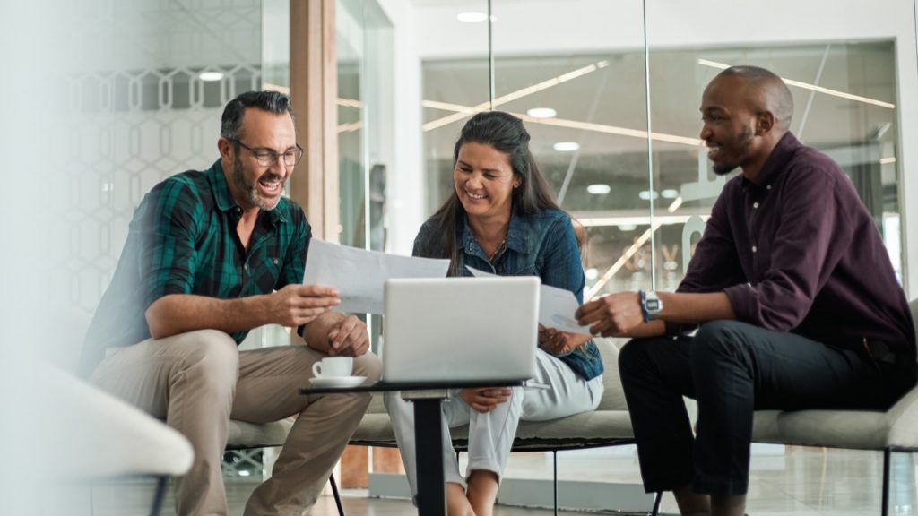 Students in a group working on laptop